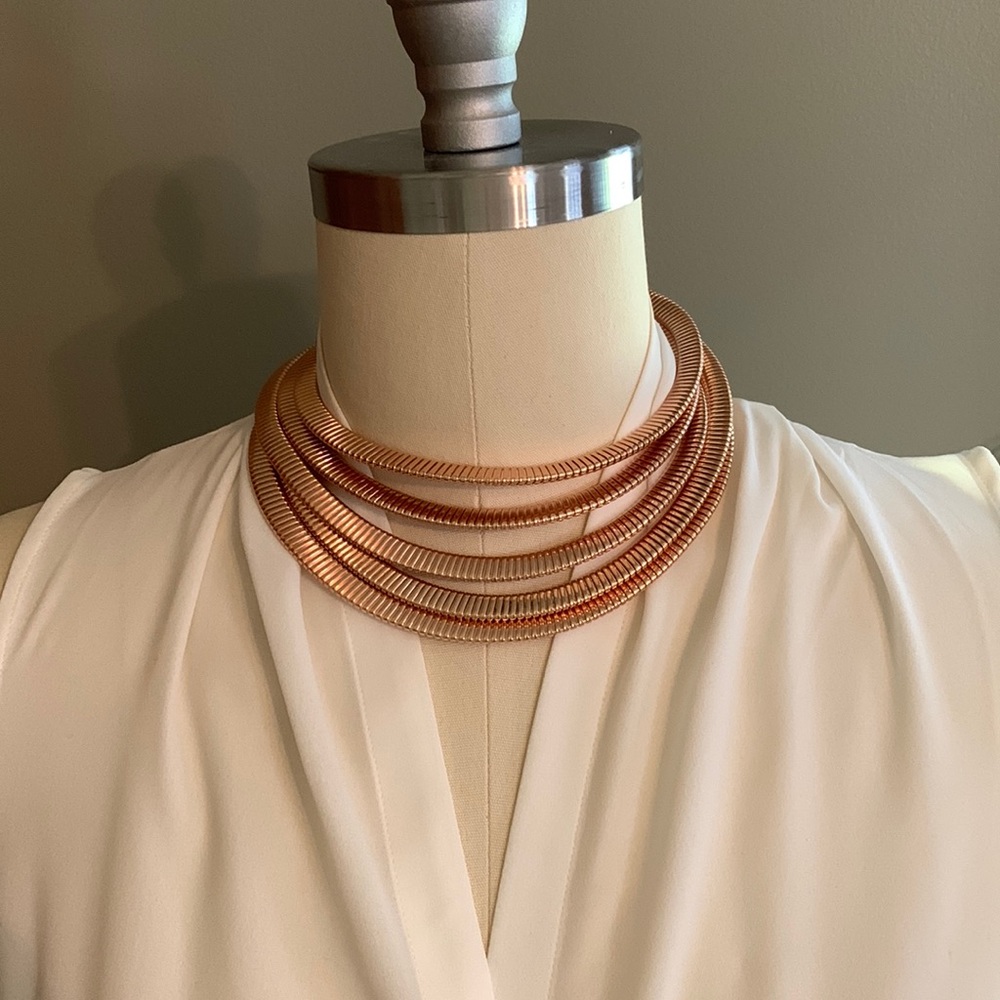 Necklace Five layers Extends to 20”. Metal rose gold color. Lobster claw clasp.